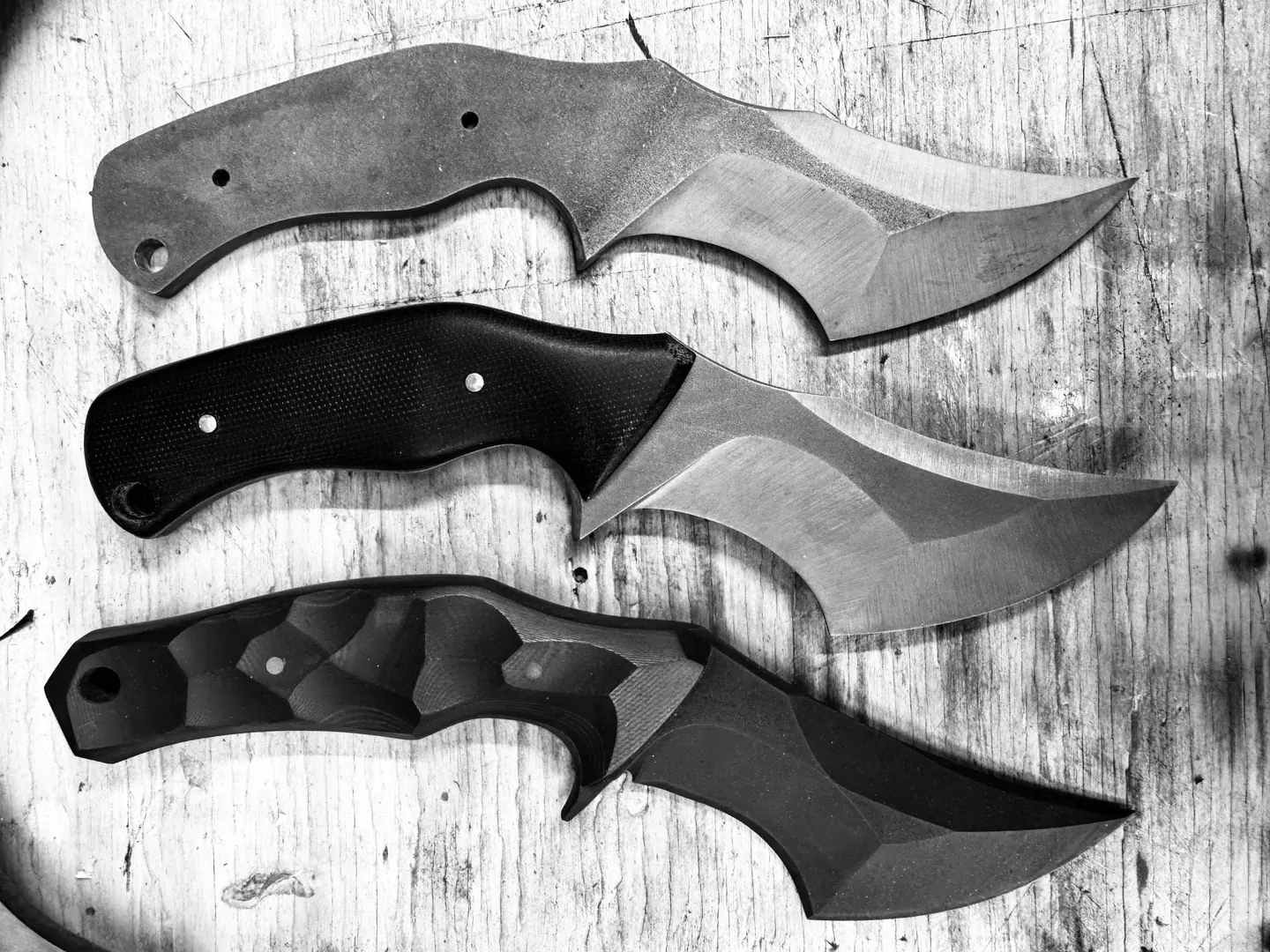 Three stages of the Crusader knife design on worn wood Three stages of the Crusader knife design on worn wood