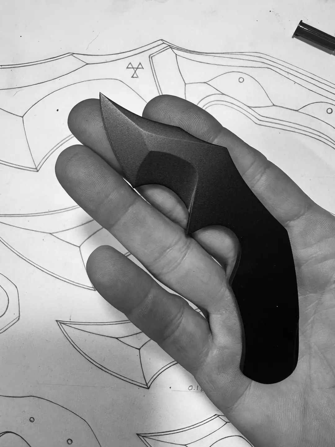 Mini Crusader prototype held over knife drawings Mini Crusader prototype held over knife drawings