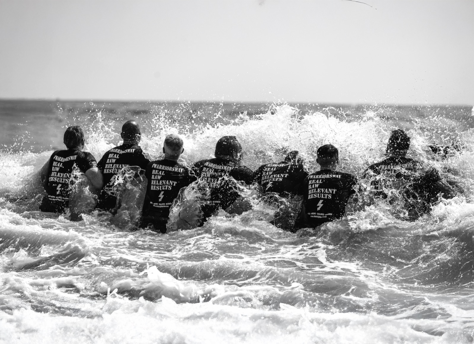 Warrior Week Brotherhood participants standing together in the ocean
